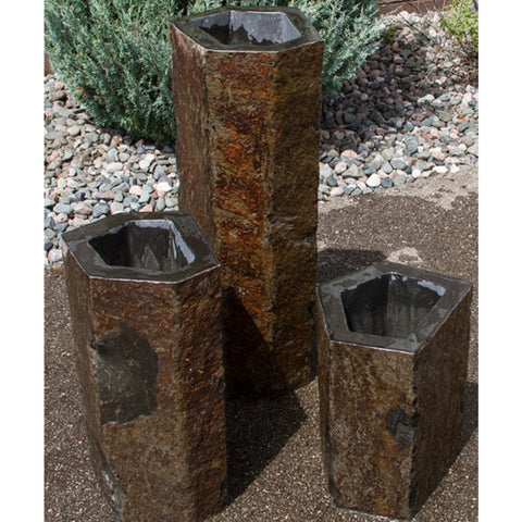 Outdoor Basalt Column Fountain With Green Plant Behind