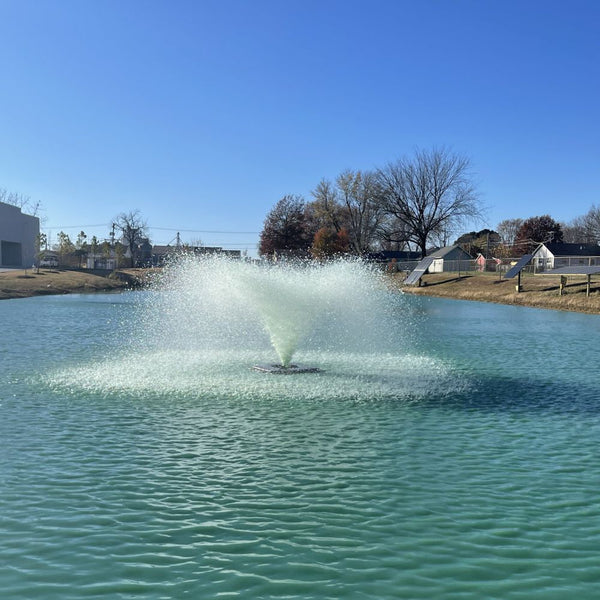 Outdoor Water Solutions Classic Series Electric Pond Aerator Fountain On The Water With Houses In The Background