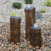 Polished Top Basalt Rock Column Fountain On Rock-Filled Garden Bed