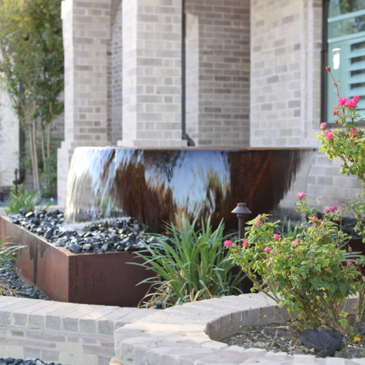 Rustic Sugar Kettle Powder-Coated Cast Iron Fountain Water Flowing  With Brick Wall House And Flowers