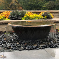 Thumbnail for Rustic Sugar Kettle Powder-Coated Cast Iron Fountain With Water Flowing  With Stone Wall And Flowers On Outdoor Patio Landscape