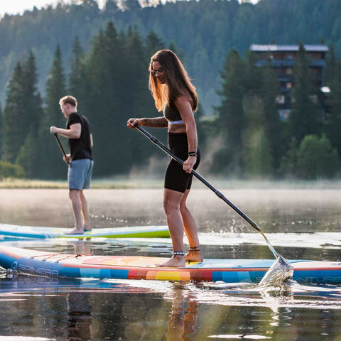 SUP Spinera Supventure Sunset 10.6 A Couple Paddling Together with Trees in the Background