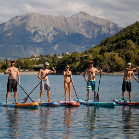 SUP Sunset 10.6 A Group Paddling Together with Mountain Background
