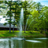 Thumbnail for Scott Aerator Clover Pond Fountain On The Water With A House In The Background