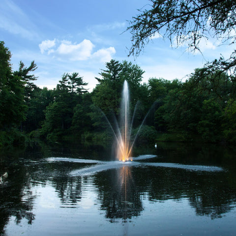 Scott Aerator Clover Pond Fountain On The Water With Lights At Dusk