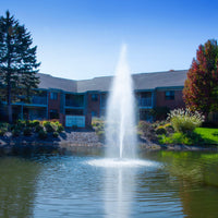 Thumbnail for Scott Aerator Gusher Fountain On The Water With A Building In The Background