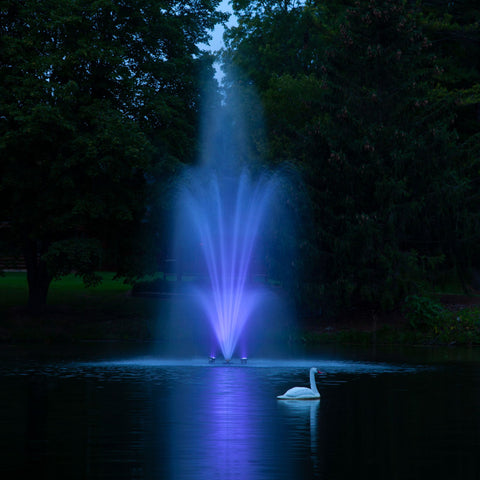 Scott Aerator Pond Fountain On Water With Purple Lights At Night
