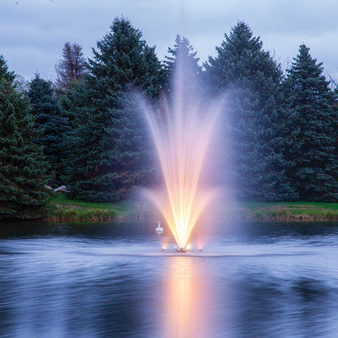 Scott Aerator Amherst Pond Fountain With Lights And Trees In The Background