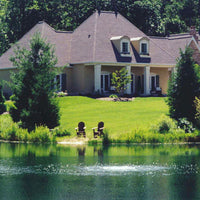 Thumbnail for Scott Aerator Bubble Pro Sub-Surface Aerator In The Water Bubbling On The Surface With A House In The Background