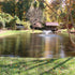 Thumbnail for Scott Aerator DA-20 Solar Pond Aerator Fountain On The Water With Trees & A Bridge In The Background