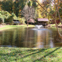 Thumbnail for Scott Aerator DA-20 Solar Pond Aerator Fountain On The Water With Trees & A Bridge In The Background