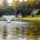 Scott Aerator DA-20 Solar Pond Aerator Fountain On The Water With Trees In The Background