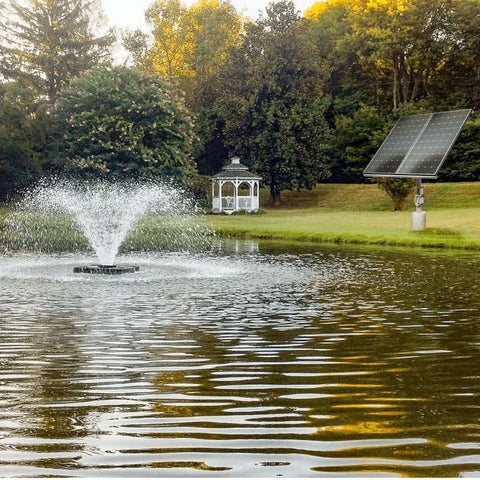 Scott Aerator DA-20 Solar Pond Aerator Fountain On The Water With Trees In The Background