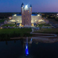 Thumbnail for Scott Aerator Jet Stream Pond Fountain With Blue Lights On The Water With A Building In The Background Top View