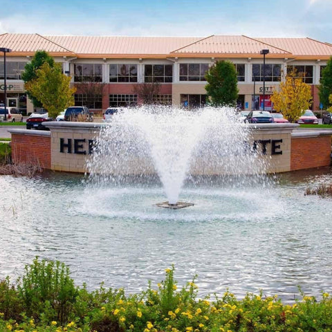 Scott Aerator North Star Pond Aerator Fountain With A Building In The Background