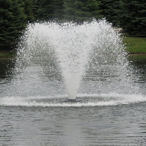 Scott Aerator North Star Pond Aerator Fountain On The Water With Green Trees In The Background