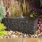 Shizukesa Stone Outdoor Fountain Surrounded By Colorful Plants And Flowers