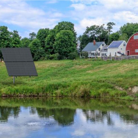 SolarSeries Direct Drive Aeration System from Airmax Solar Aerator On Farm Near Pond With Two Houses And Trees In The Background