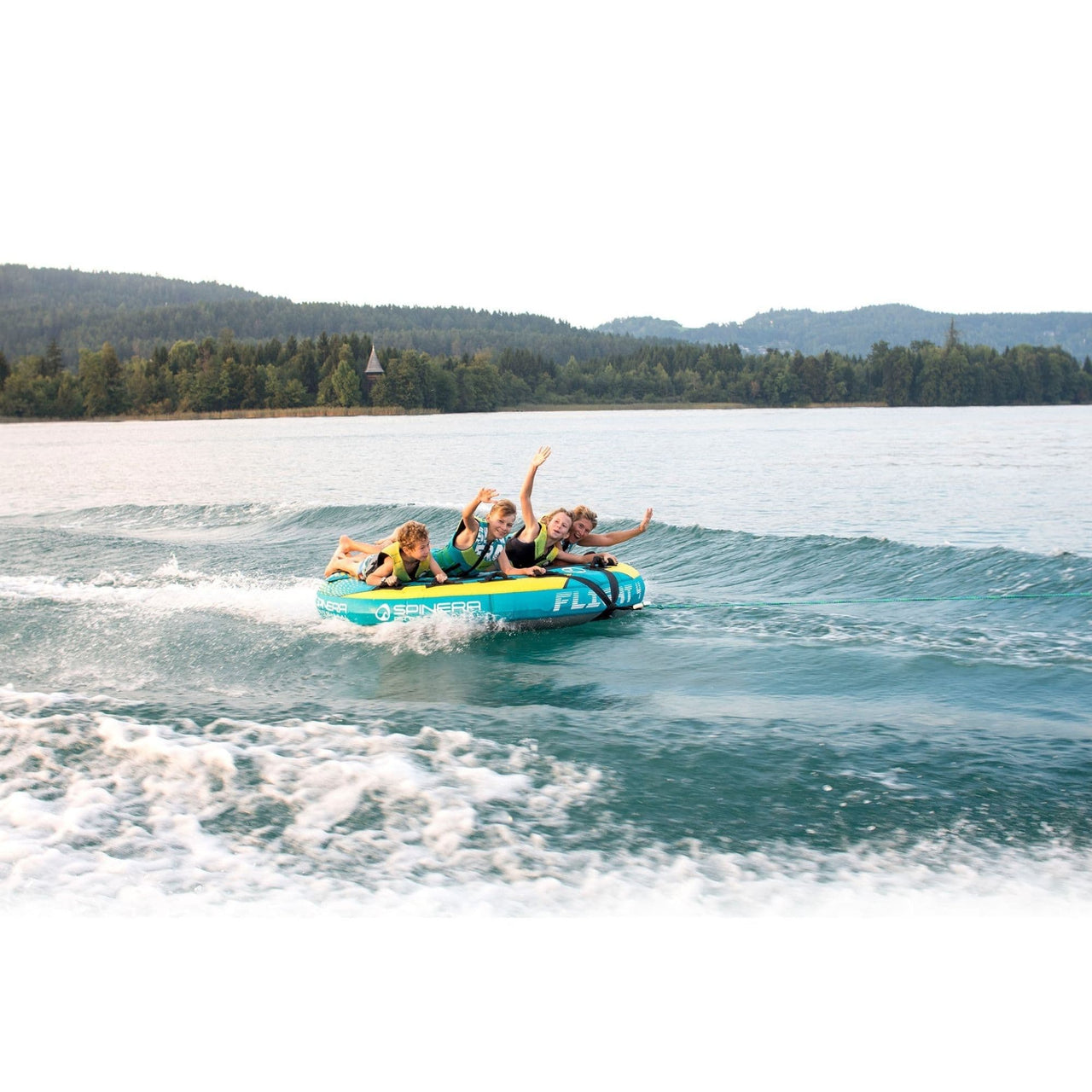 Spinera Flight 4 Person Towable With Kids Waving While Enjoying the Ride