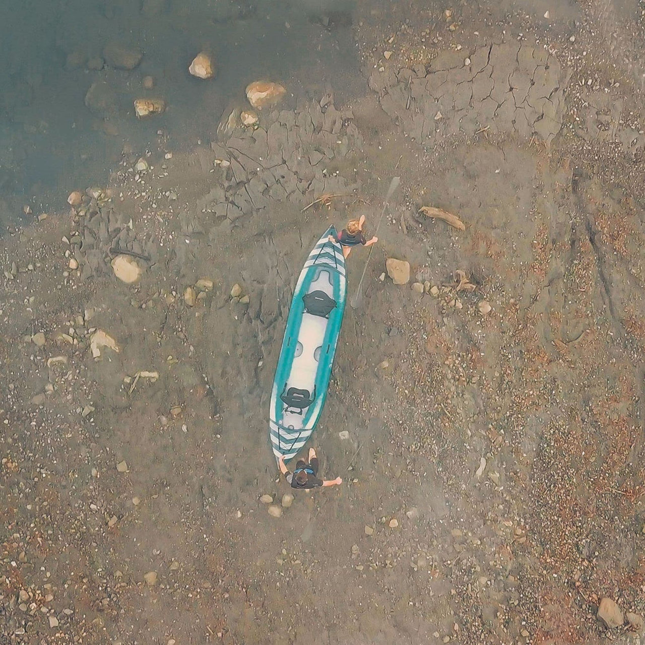 Spinera Hybris 410 Top View With Two People Carrying By The Lake Shore