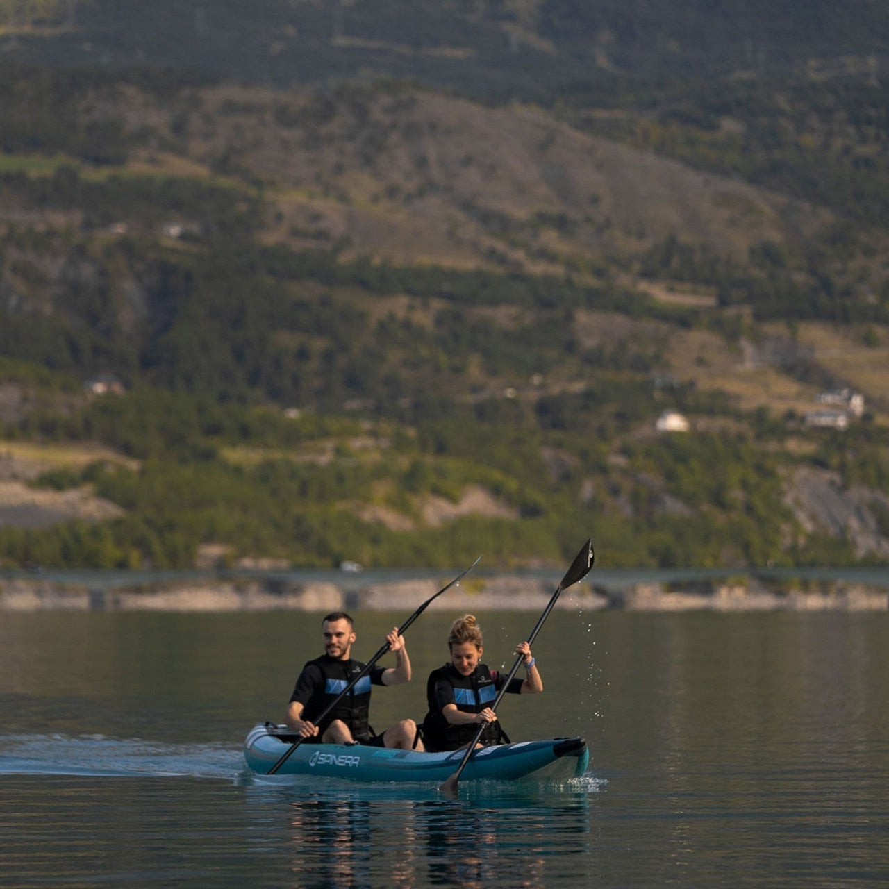 Spinera Hybris 410 With Man And Women Kayaking With Mountain View