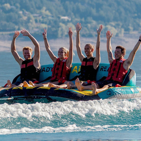 Spinera Just Fun 4 Person Towable With Four People Raising Hands on Water Ride