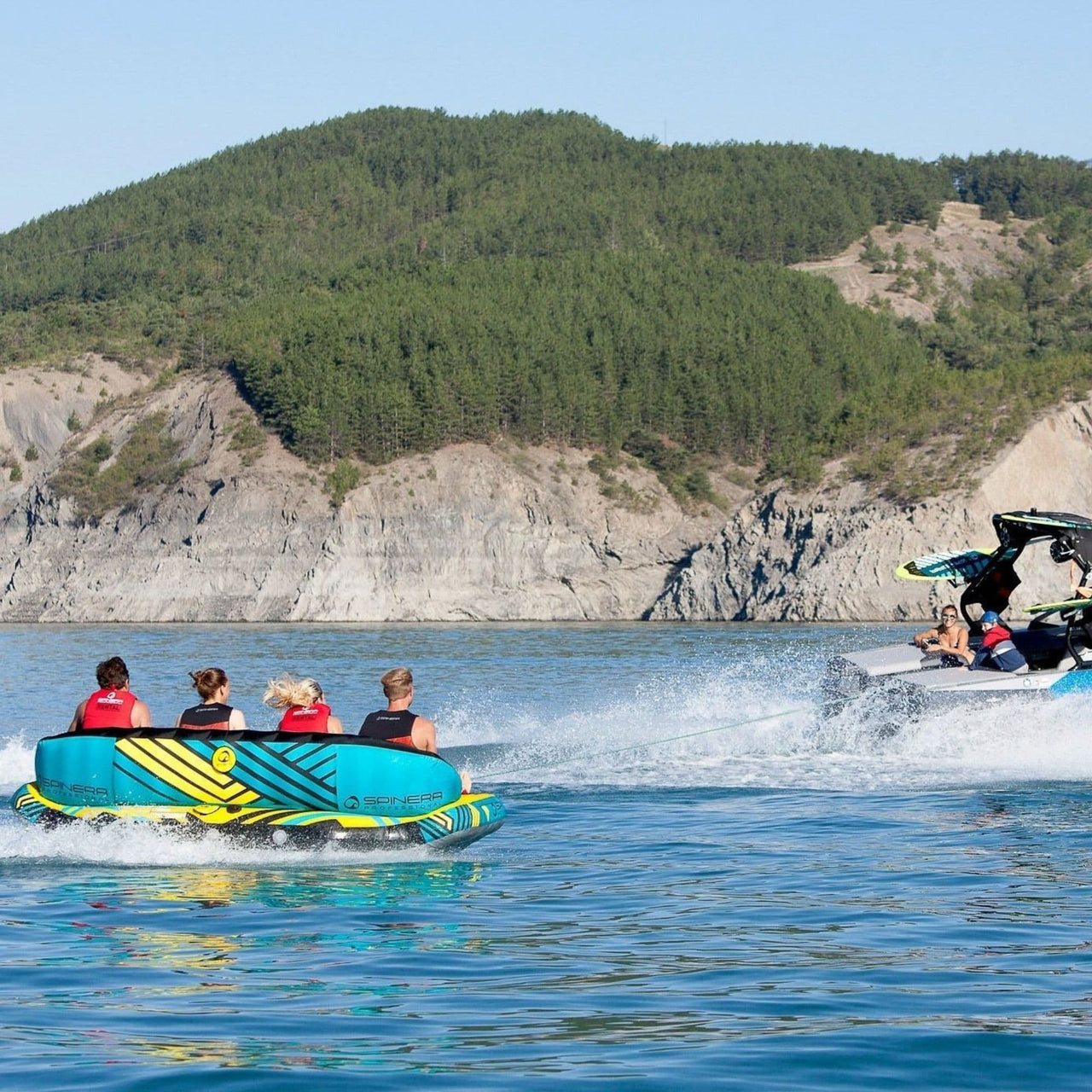 Spinera Just Fun 4 With Riders Enjoying the Ride While Boat Towing Tube
