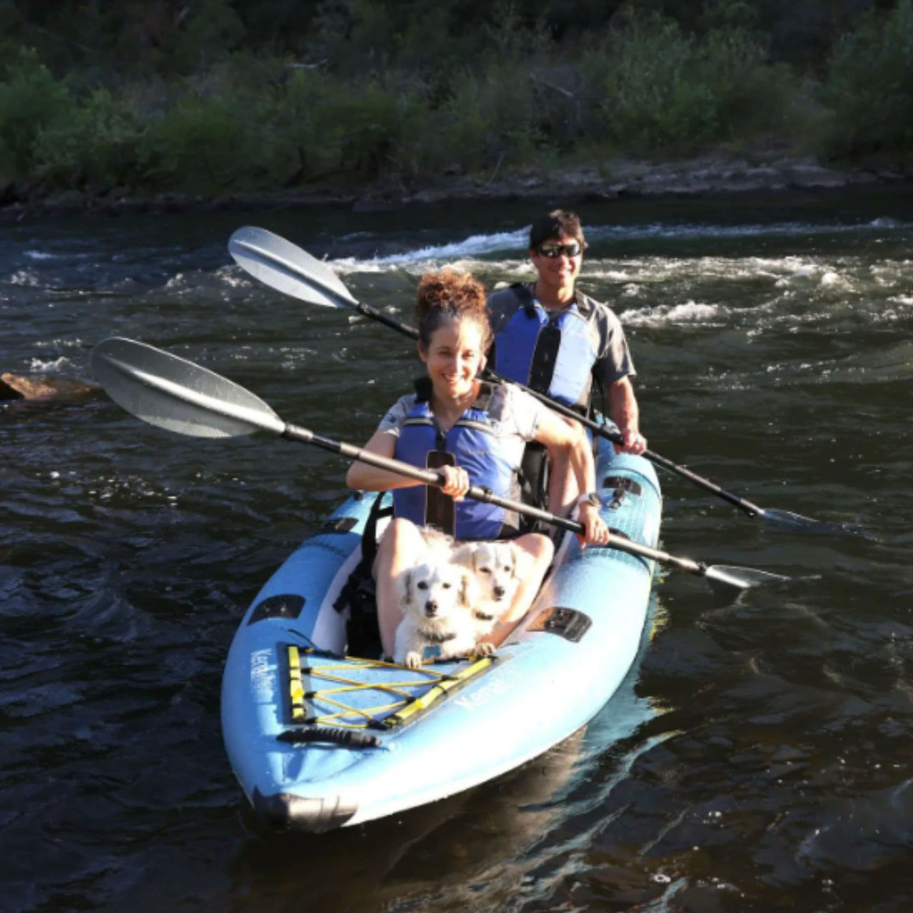 Spinera Kenai 130 With A Man And Woman  Happily Paddling Together With Dogs On River