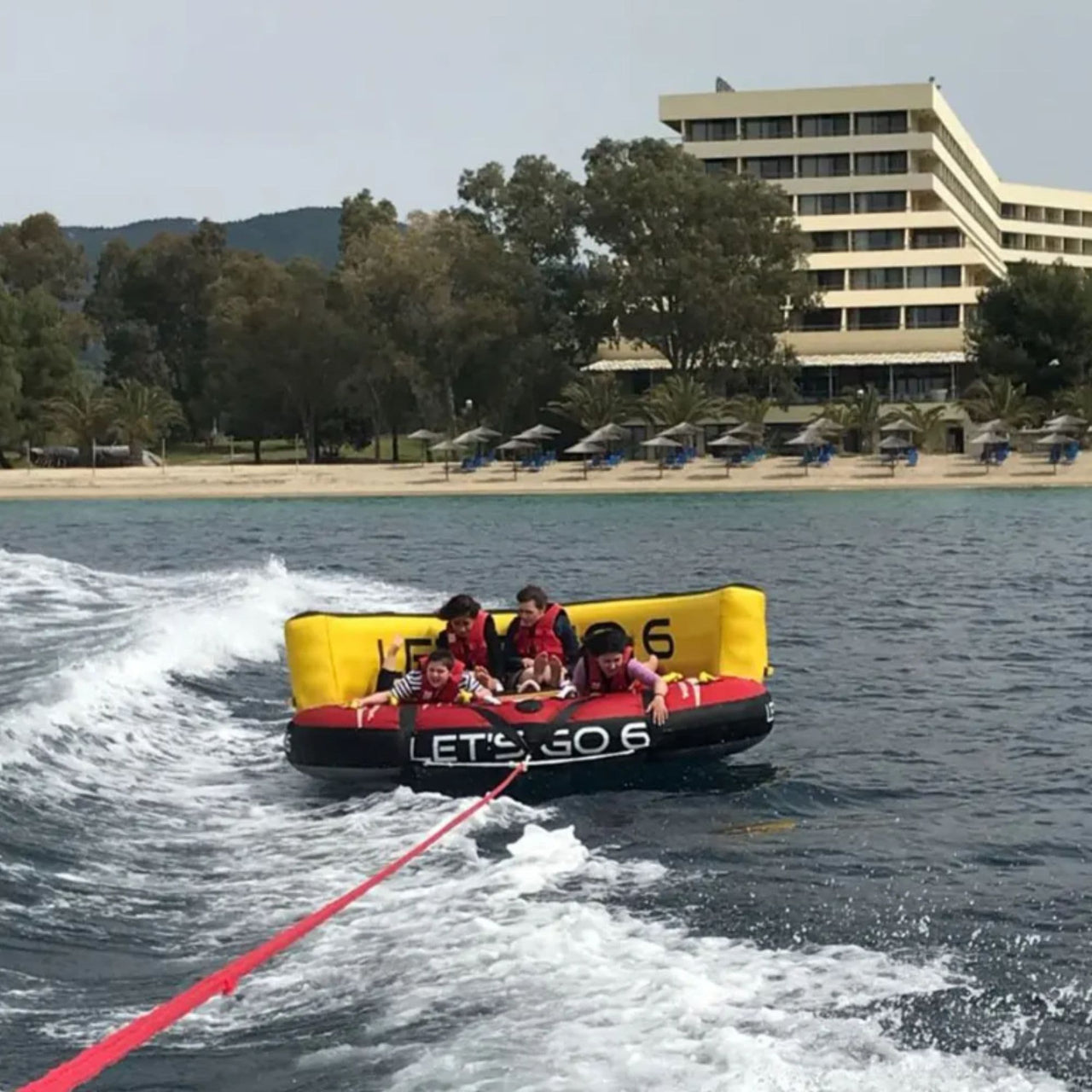 Spinera Let’s Go 6 Person Towable Four People Enjoying The Thrill Of The Ride As They Go With The Flow Of The Waves