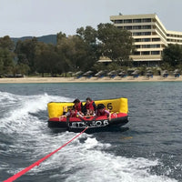 Thumbnail for Spinera Let’s Go 6 Person Towable Four People Enjoying The Thrill Of The Ride As They Go With The Flow Of The Waves