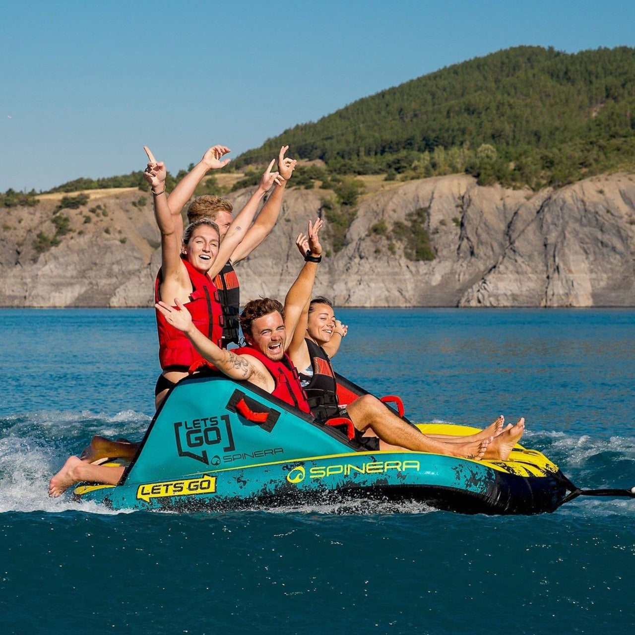 Lets_Go_Family_4_Towable_With_Four_Friends_Hands_Up_Together_While Enjoying_the_Ride