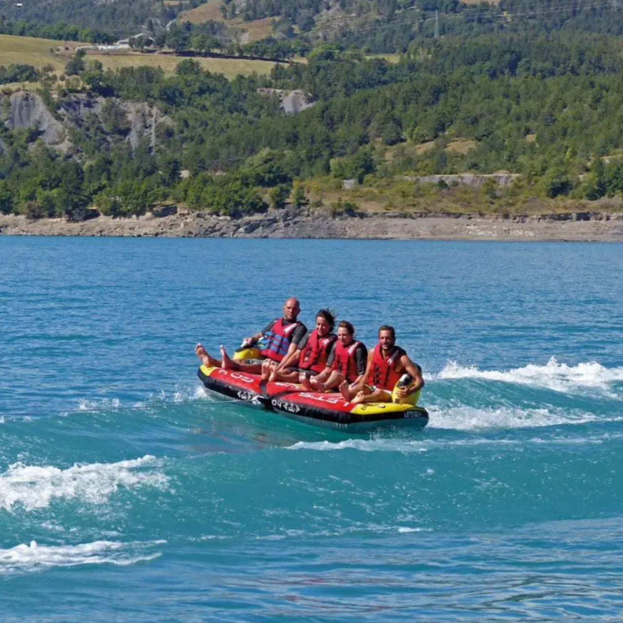Spinera Lets Go 4 Person Towable With Four Friends Riding And Mountain All Around