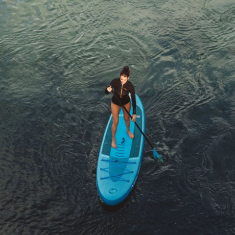 Spinera Lets Paddle 10.4 Paddle Board With a Woman Paddling On Open Water