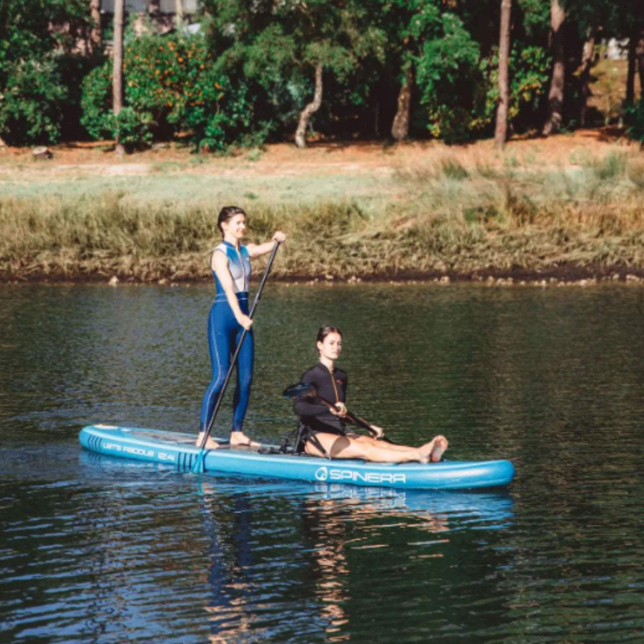 Spinera Lets Paddle 12.4 Paddle Board With Two Girls Paddling Together Near Lake Shore