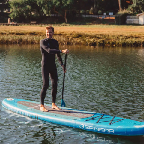 Spinera Lets Paddle 12.4 With a Man Paddling Through Calm Water