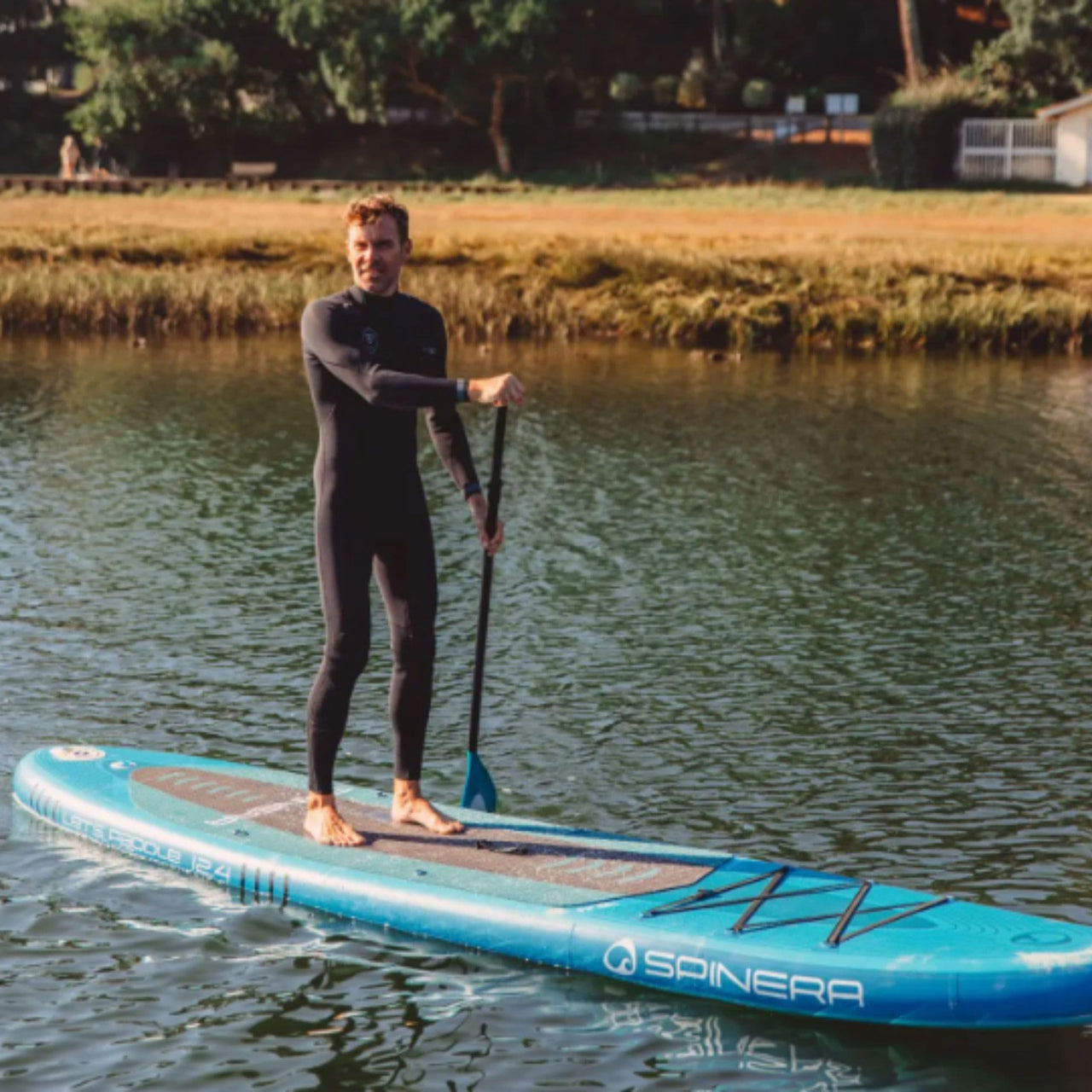 Spinera Lets Paddle 12.4 With a Man Paddling Through Calm Water