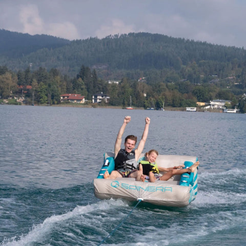 Spinera Lounger 2 Person Towable With Two Boys Enjoying the Waves While Tubing