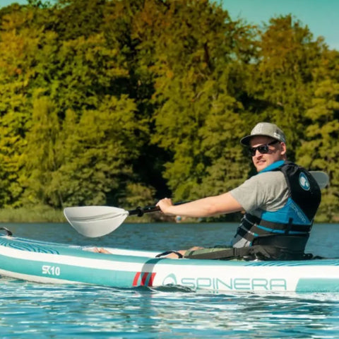 Spinera SK10 With a Man Kayaking on Calm Water