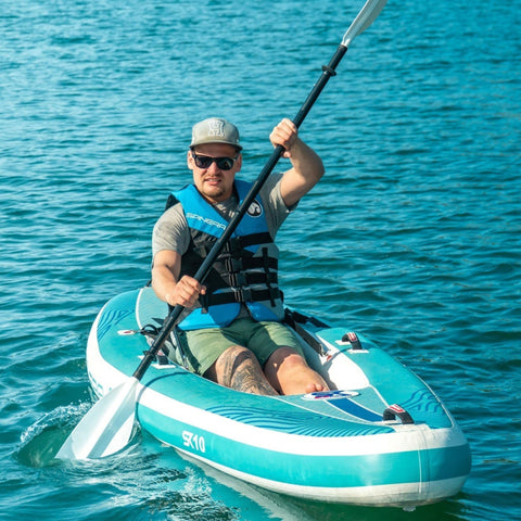 Spinera SK10 With a Man Paddling on Calm and Clear Water