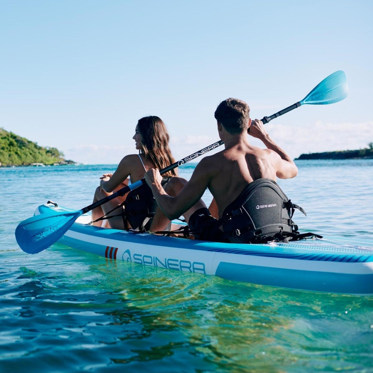 Spinera SK12 SUP Kayak With a Couple Kayaking Together On Clear Blue Sea