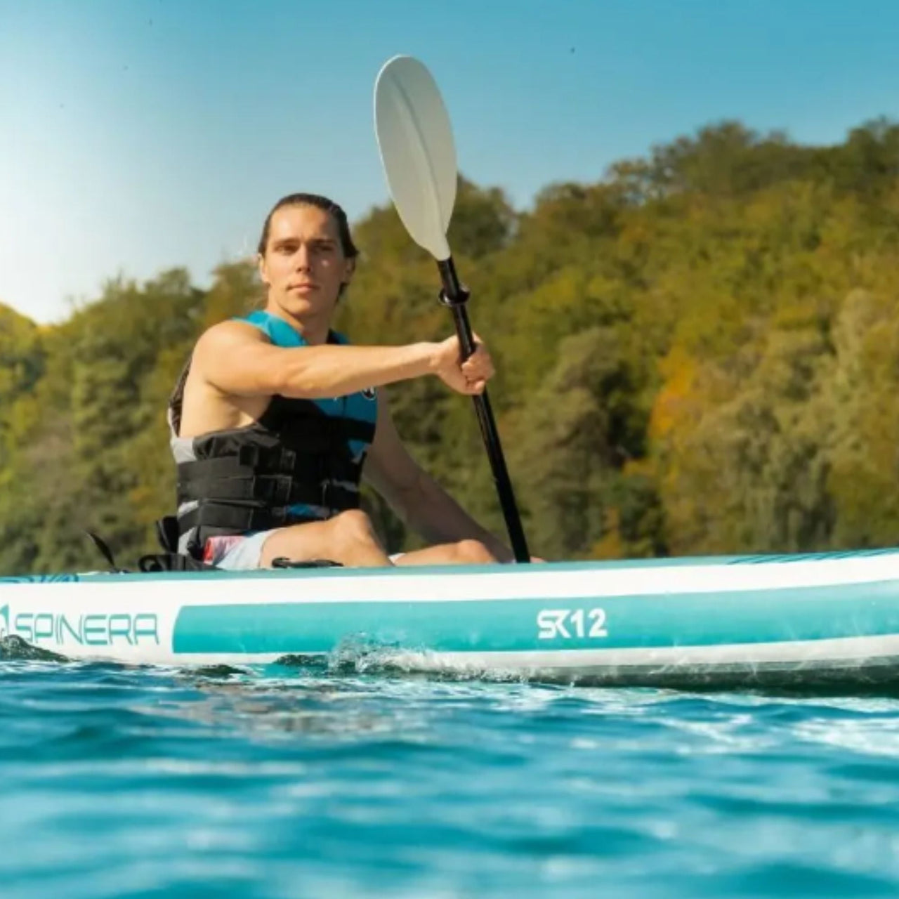 Spinera SK12 With a Man Paddling on Clear Water
