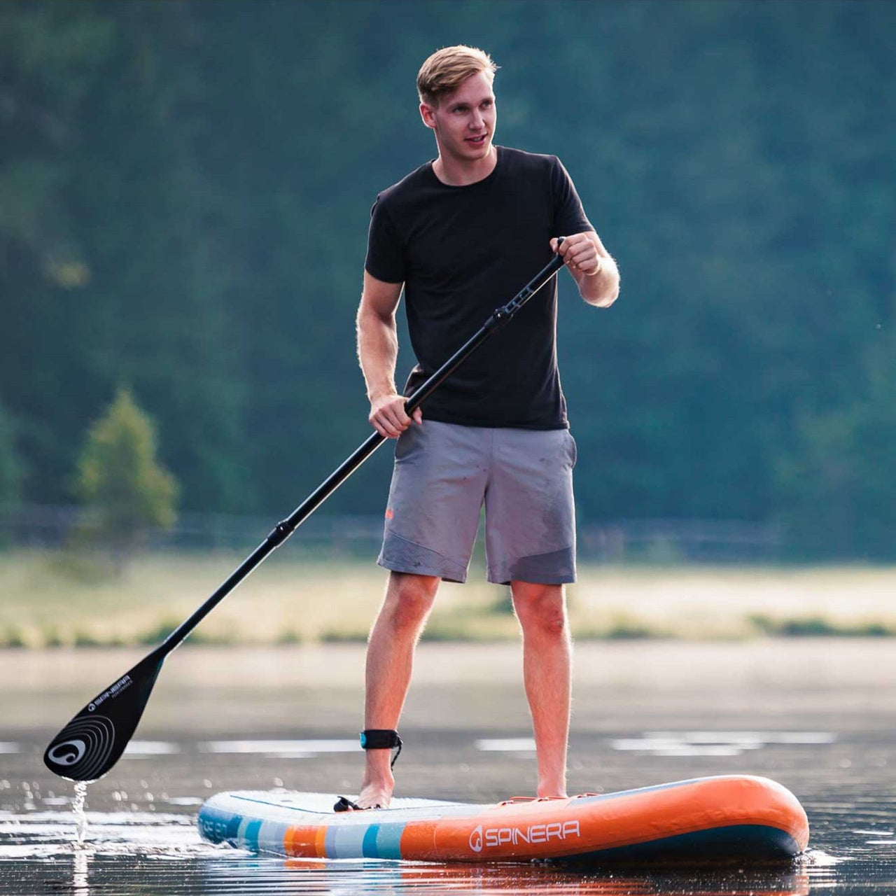 Spinera SUP Supventure Sunrise 12.0 With a Man Paddling on Calm Water