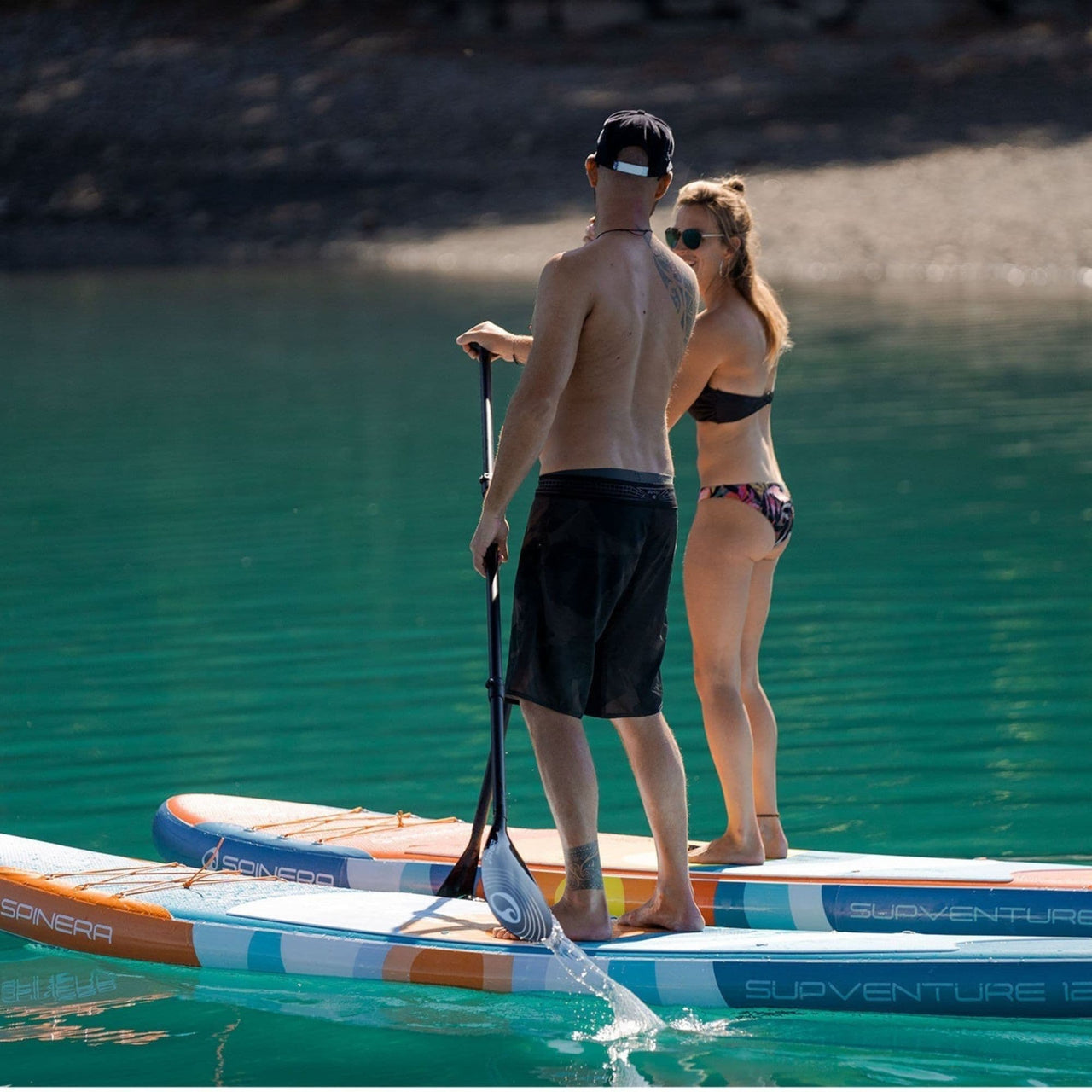 Spinera SUP Supventure Sunrise 12.0 With a Man and Woman Paddling Calmly