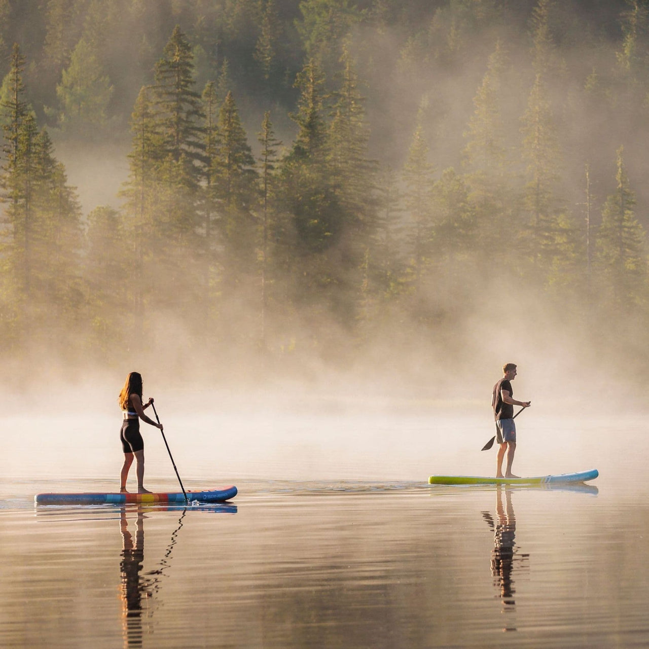 Spinera SUP Supventure Sunset 10.6 With a Man and Woman Paddling on Misty Lake
