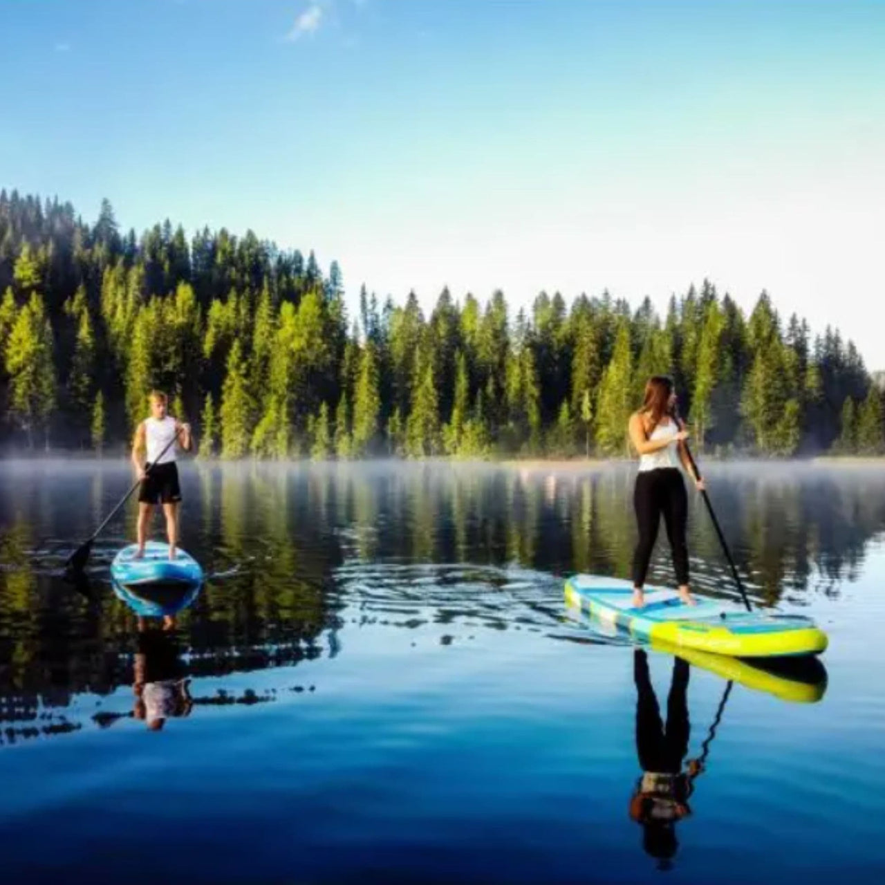 Spinera Sun Light 10.2 Paddle Board With a Man and Woman Paddling on Calm Water