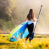 Thumbnail for Spinera Sun Light 1.0 Paddle Board With A Woman Walking Carrying The Paddle and The Board
