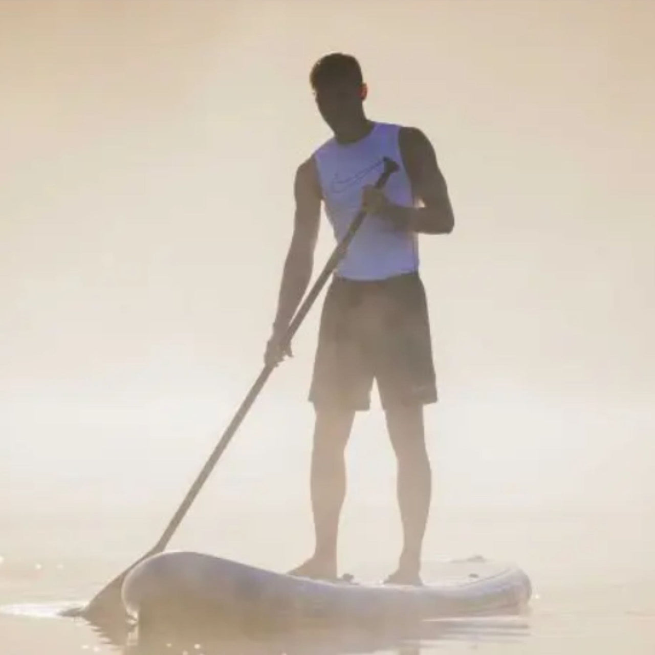 Spinera Sun Light 12.0 Paddle Board With a Man Paddling on a Misty Lake