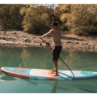Thumbnail for Spinera Supventure Sunrise 12 Paddle Board With A Man Paddling in Calm Water with Trees