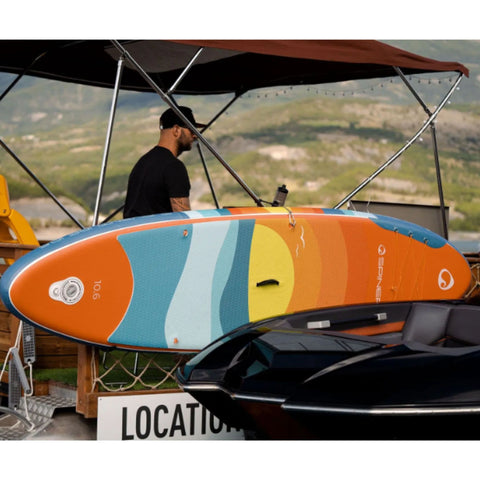 Spinera Supventure Sunset 10.6 Paddle Board With a Man Sailing on a Boat