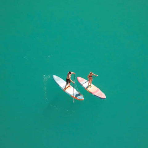 Spinera Supventure Sunset 10.6 Paddle Board With a Two People Paddling on Clear Water